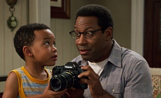 Black_american_dad_showing_his_son_how_to_operate_a_di_2